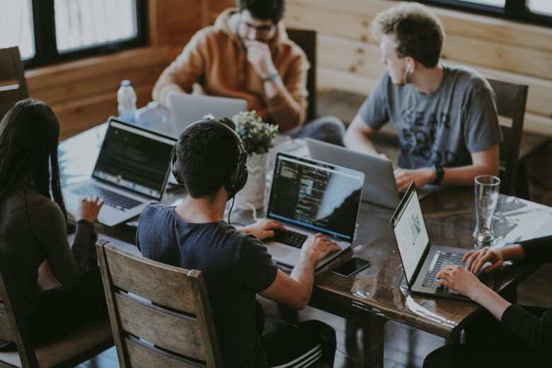 Team working together on a laptop with the best free CRM for small business