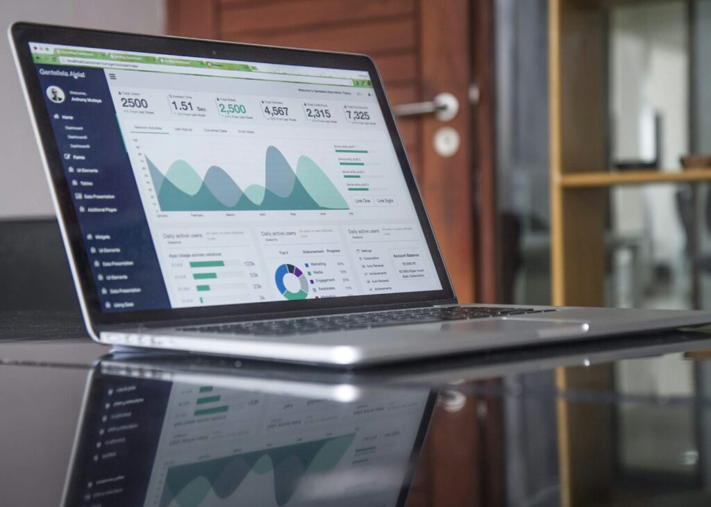 Laptop showing charts of paid and overdue invoices in a small business