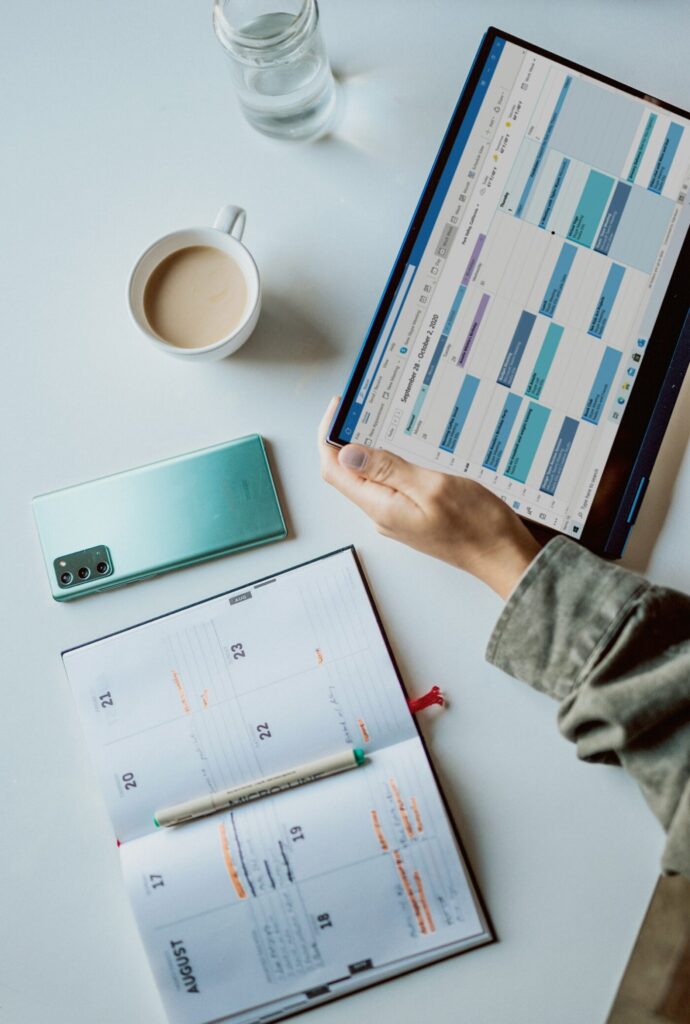 Business owner managing online bookings on a tablet and laptop