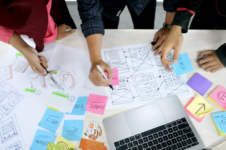 Person sketching a project plan on paper before using project management tools