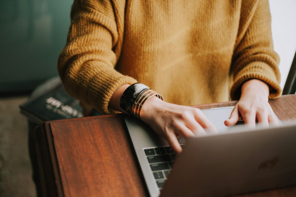 Person using a laptop to capture a screen recording with audio