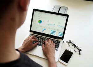 Freelancer reviewing charts on a laptop with the best accounting software for freelancers