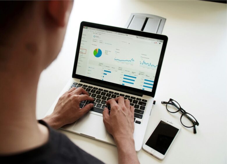 Freelancer reviewing charts on a laptop with the best accounting software for freelancers